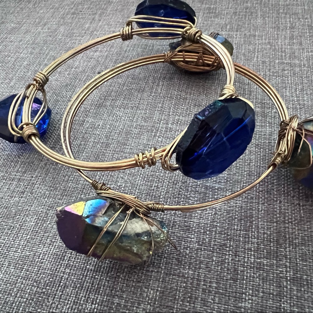 Two Gold Toned Bangels With three Stones on each.